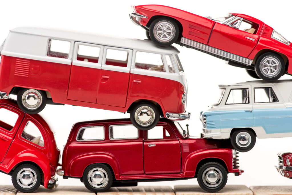 colorful toy cars and toy bus isolated on white
