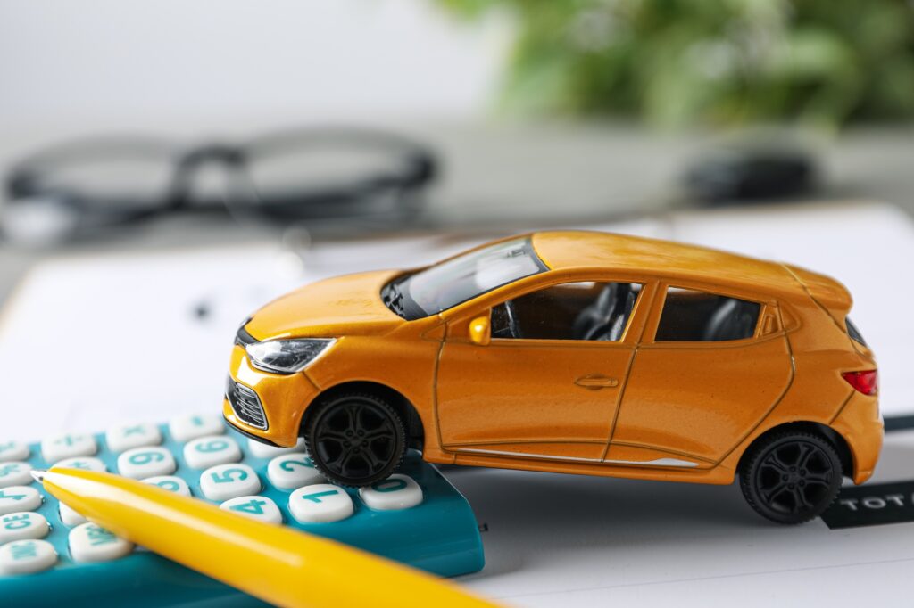 Concept of car purchase and insurance with toy car